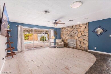 Living room w/ fireplace and sliding doors our to