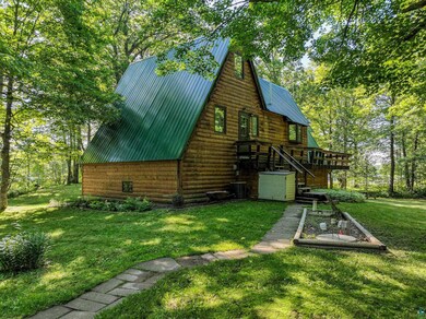 Rear view of house featuring central AC and a lawn