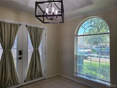 Unfurnished dining area with a chandelier, light tile patterned flooring, and ornamental molding