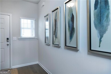 Entryway featuring dark wood-style floors and baseboards