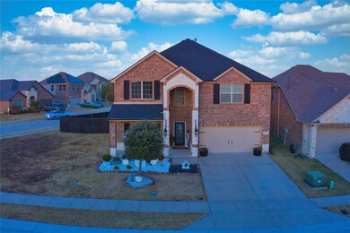 View of front of house with a garage and a front lawn