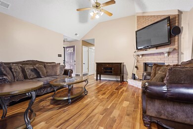 Living room featuring ceiling fan, a textured ceil
