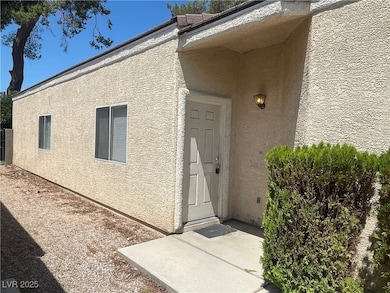 Property entrance featuring stucco siding