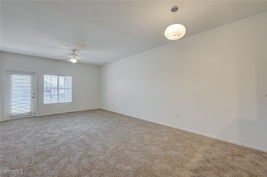 Spare room featuring light carpet and ceiling fan