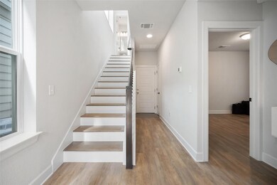 Stairway featuring wood finished floors and reces