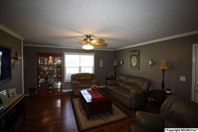 Features include laminate flooring, ceiling fan and crown molding.