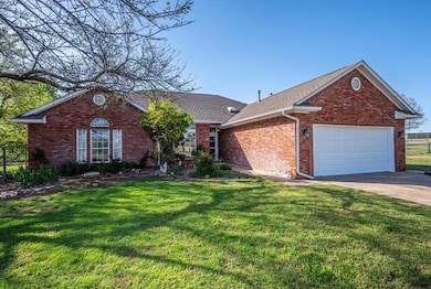 Single story home featuring concrete driveway, roo