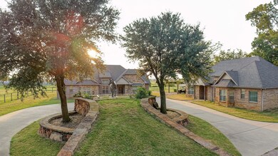 View of front of house featuring a front yard, a shingled roof, and driveway