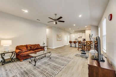 Living room featuring ceiling fan and light hardwood / wood-style flooring
