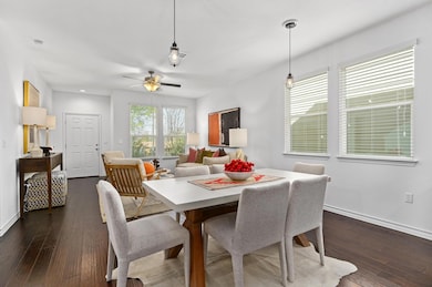 Dining space with dark wood-style floors, ceiling