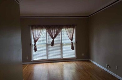 Living room featuring ornamental molding, baseboar