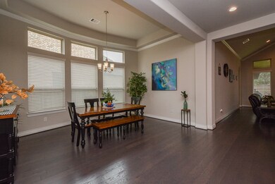 As we walk through the long/wide main hallway, scenes like this will be presented for you! This space would be perfec as your traditional, formal dining space! A wall of windows light your time here. Note the contination of color theme and wall and ceiling accents.