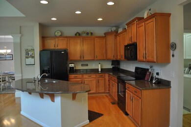 Spacious Kitchen with lots of cabinetry, granite counters, Cabinet pull outs, hardwoods throughout the entire living area on the first floor.