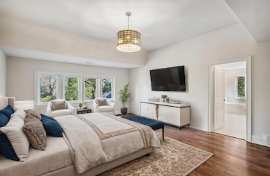 Bedroom with wood-type flooring, a notable chandel