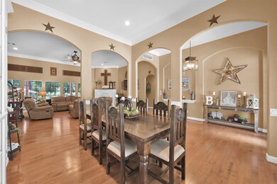 Spacious arched wall accents enable the area to be divided while remaining easily accessible from both the kitchen and the den.