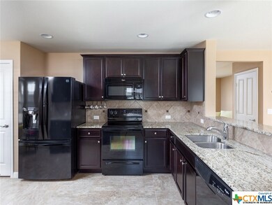 Keep your measuring cups handy with under-cabinet hangers. The door on the left is the pantry. The door on the right outside the kitchen is a deep closet.