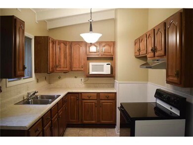 Newer Oak Cabinets with stove top range.