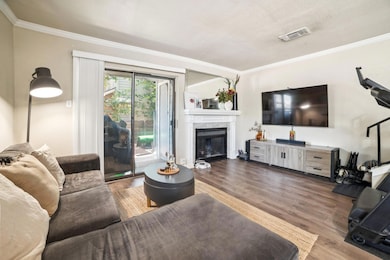 Living room featuring ornamental molding, wood fi
