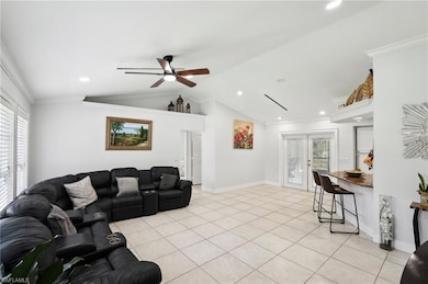 Living area featuring crown molding, visible vents
