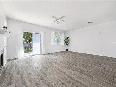 Unfurnished living room featuring light wood-style flooring, a fireplace, and ceiling fan