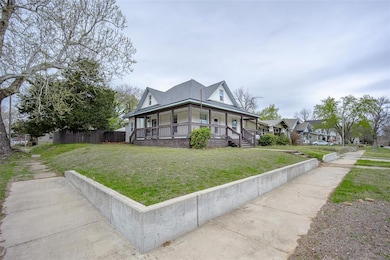 View of front of house featuring a front lawn, cov