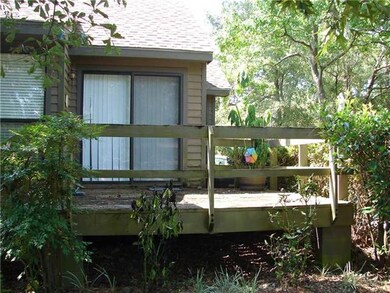 Exterior Back. Rear Deck with Sliding Doors to Din