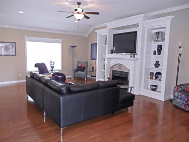 Spacious great room with hardwood flooring, 9' cei