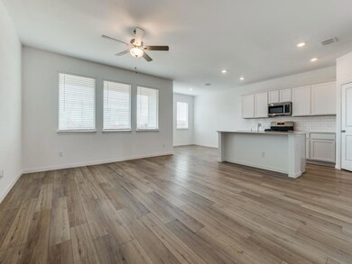 Wall of windows overlooking spacious backyard.