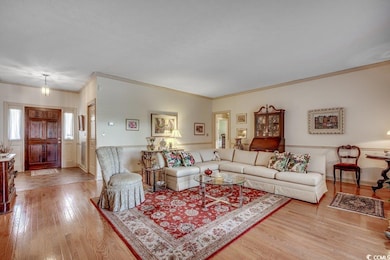 Living room with a textured ceiling, crown molding