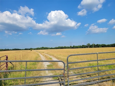 Gated entrance with private field road down middle