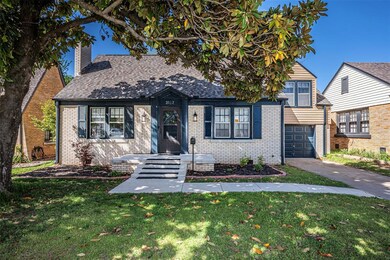 The street view of the home with a grand Magnolia tree framing this historical home!