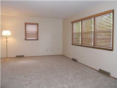 The large living room features all new carpet, new