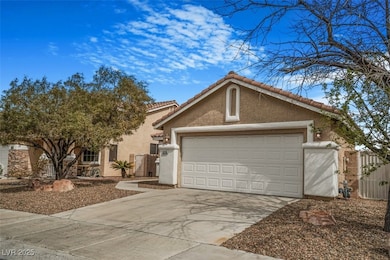 View of front of property featuring driveway, a ga