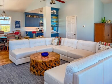 Living area with ceiling fan with notable chandeli