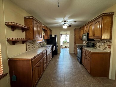 Kitchen with tile floors and counter tops.