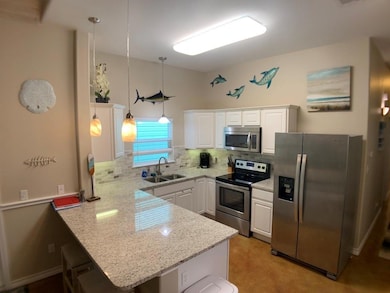 Kitchen with stainless steel appliances, a penins