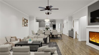 Living Area with crown molding, wood finished floors, and a ceiling fan