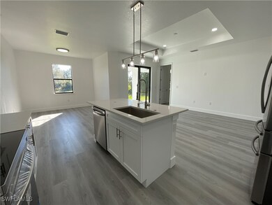 Kitchen featuring dishwasher, sink, pendant lighti