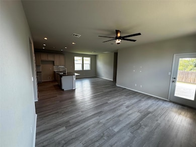 Unfurnished living room featuring recessed lighting, dark wood-style flooring, and a ceiling fan