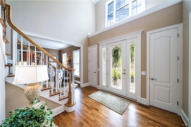 Foyer with Hardwood Flooring and Dual Closets
