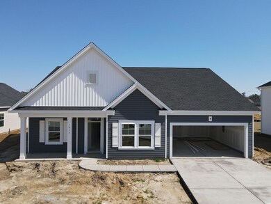 View of front of home with concrete driveway, a ga