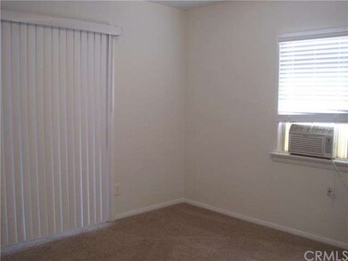 Bedroom with sliding door leading to screened-in p