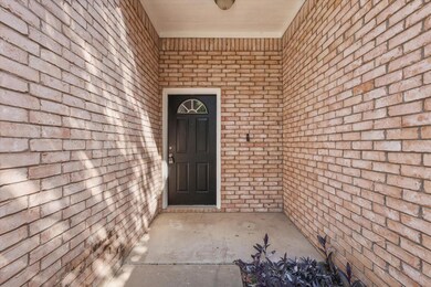 Doorway to property with brick siding