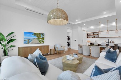 Living room with stacked washer / dryer, a tray ce