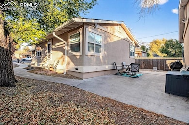 View of home's exterior featuring stucco siding, a patio area, and crawl space