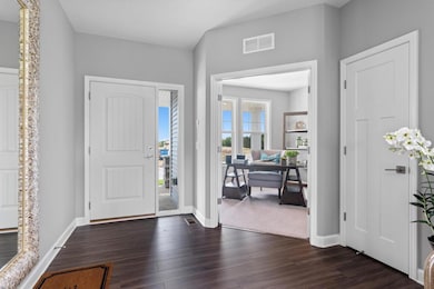 The bright and open entry space is on display as it opens to the main floor office and great room. (model photo) Plan and Finishes will vary.