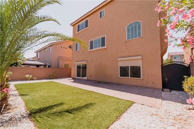 Back of property with stucco siding, a patio, and