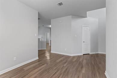 Spare room featuring wood finished floors and lof