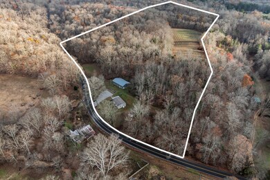 Aerial view shows property lines and a large open field toward the back of the property.  Tax shows 980 feet of road frontage on Harris Road.