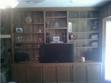 FAMILY ROOM HAS NICE BUILT IN CABINETS AND SHELVES